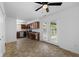 Spacious kitchen-dining area with stainless steel appliances, wood cabinets, and a ceiling fan at 916 Ardsley Dr, Indianapolis, IN 46234