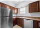 Bright kitchen featuring stainless steel appliances, wood cabinets, and a double sink at 916 Ardsley Dr, Indianapolis, IN 46234