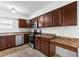 Kitchen with stainless steel appliances, wood cabinets, and a countertop space at 916 Ardsley Dr, Indianapolis, IN 46234