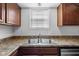 Kitchen features a stainless steel sink, neutral countertops, and wood cabinets at 916 Ardsley Dr, Indianapolis, IN 46234