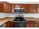 Kitchen details featuring stainless steel appliances, wood cabinets, and modern design at 916 Ardsley Dr, Indianapolis, IN 46234