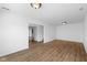 Open-concept living room with wood-look floors and bright neutral walls and natural light at 916 Ardsley Dr, Indianapolis, IN 46234