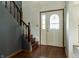 Inviting entryway with hardwood floors, staircase, and a decorative glass front door at 925 Mallory Pkwy, Franklin, IN 46131