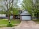 Charming two-story home with a well-manicured front lawn and mature trees at 925 Mallory Pkwy, Franklin, IN 46131