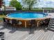 Above-ground pool featuring a built-in deck with chairs, stairs, and decorative fish at 925 Mallory Pkwy, Franklin, IN 46131