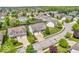 Wide aerial view of the property showcasing mature trees, manicured lawns, and the surrounding neighborhood at 9712 Brooks Dr, McCordsville, IN 46055