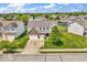 Expansive aerial view of a well-maintained home with a spacious driveway and lush landscaping at 9712 Brooks Dr, McCordsville, IN 46055