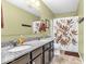 Granite countertop vanity featuring dual sinks, a large mirror, and decorative shower curtain at 9712 Brooks Dr, McCordsville, IN 46055