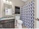 Bathroom features a vanity with granite countertops and a patterned shower curtain at 9712 Brooks Dr, McCordsville, IN 46055