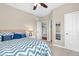 Well-lit bedroom with a large bed and a view into the en-suite bathroom and closet at 9712 Brooks Dr, McCordsville, IN 46055