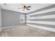 A bedroom featuring soft carpet, horizontal accent stripes and two windows for natural light at 9712 Brooks Dr, McCordsville, IN 46055