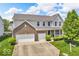 Charming two-story home with a brick facade, manicured landscaping, and a two-car garage at 9712 Brooks Dr, McCordsville, IN 46055