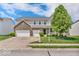 Charming two-story home boasts a well-manicured lawn, a two-car garage, and appealing curb appeal at 9712 Brooks Dr, McCordsville, IN 46055