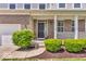 Welcoming front porch featuring classic columns, neat landscaping and a stylish black front door at 9712 Brooks Dr, McCordsville, IN 46055