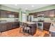 Modern kitchen with stainless steel appliances, a central island, and dark wood cabinetry at 9712 Brooks Dr, McCordsville, IN 46055