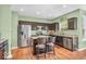 Open concept kitchen with stainless steel appliances, hardwood floors and a breakfast bar at 9712 Brooks Dr, McCordsville, IN 46055