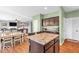 Open-concept kitchen and dining area with hardwood floors seamlessly flow into the cozy living room at 9712 Brooks Dr, McCordsville, IN 46055