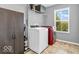 Well-lit laundry room with modern washer and dryer set and ample storage space at 9712 Brooks Dr, McCordsville, IN 46055