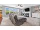 Cozy living room features a plush couch, fireplace, modern ceiling fan and lots of natural light at 9712 Brooks Dr, McCordsville, IN 46055