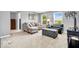 Spacious living room with neutral tones, ample seating, and natural light from large windows at 9712 Brooks Dr, McCordsville, IN 46055