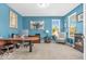 Bright home office features a large desk, comfortable seating and a serene blue color scheme at 9712 Brooks Dr, McCordsville, IN 46055