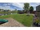 Spacious backyard featuring a pond, trampoline, fire pit, and slide for outdoor enjoyment at 98 Frostwood Ln, Greenwood, IN 46143