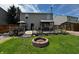 Beautiful backyard featuring a deck, fire pit, lush lawn, and privacy fence at 98 Frostwood Ln, Greenwood, IN 46143
