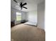 Bright bedroom featuring neutral carpet, white walls, a ceiling fan, and a window at 98 Frostwood Ln, Greenwood, IN 46143