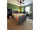 Bedroom with a wooden bed frame, a colorful quilt, and a window providing natural light at 98 Frostwood Ln, Greenwood, IN 46143