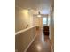 Upstairs hallway with hardwood floors and warm paint at 98 Frostwood Ln, Greenwood, IN 46143