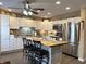 Bright kitchen with stainless steel appliances, white cabinets, kitchen island with seating and decor at 98 Frostwood Ln, Greenwood, IN 46143