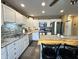 Bright kitchen with stainless steel appliances, white cabinets, kitchen island and decorative backsplash at 98 Frostwood Ln, Greenwood, IN 46143