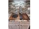 Stainless kitchen sink featuring built in accessories, modern faucet, granite countertops and tile backsplash at 98 Frostwood Ln, Greenwood, IN 46143
