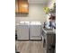 Functional laundry room with a washer, dryer, utility sink, and ample shelving for storage at 98 Frostwood Ln, Greenwood, IN 46143