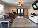 Inviting living room with hardwood floors, ceiling fan, and plenty of natural light at 98 Frostwood Ln, Greenwood, IN 46143