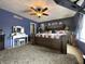 Spacious main bedroom featuring a king bed, ceiling fan, accent wall, makeup table, and hardwood floors at 98 Frostwood Ln, Greenwood, IN 46143