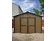 A wooden storage shed with grey trim in the backyard at 98 Frostwood Ln, Greenwood, IN 46143