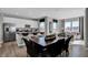 Open concept dining area with modern table, chairs, and seamless flow to a spacious kitchen and living room at 10817 Soda Creek Ct, Indianapolis, IN 46239