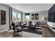Modern living room featuring a gray sofa, patterned chair, and plenty of natural light at 10817 Soda Creek Ct, Indianapolis, IN 46239