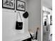 Mudroom area with a built-in storage bench, stainless steel refrigerator and hat and bag rack at 10817 Soda Creek Ct, Indianapolis, IN 46239