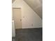 Attic with slanted walls and door at 1131 S Pershing Ave, Indianapolis, IN 46221