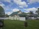 A view of the backyard with a house with a screened-in porch behind a privacy fence at 1131 S Pershing Ave, Indianapolis, IN 46221
