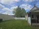 Backyard view with a privacy fence separating the neighbor's property and a large shade tree at 1131 S Pershing Ave, Indianapolis, IN 46221