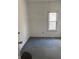 A view of the bedroom, showing a window with blinds, and blue carpeting at 1131 S Pershing Ave, Indianapolis, IN 46221