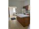 Classic kitchen with light countertops, wood cabinets, and a central island at 1131 S Pershing Ave, Indianapolis, IN 46221