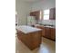 Classic kitchen featuring light countertops, wood cabinets, and an island at 1131 S Pershing Ave, Indianapolis, IN 46221
