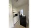 Laundry room with washer, dryer, stove, and shelves at 1131 S Pershing Ave, Indianapolis, IN 46221