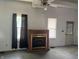 This is a well lit living room featuring a fireplace, natural lighting, and a ceiling fan at 1131 S Pershing Ave, Indianapolis, IN 46221