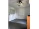 A partially staged living room featuring a ceiling fan, and large blank walls at 1131 S Pershing Ave, Indianapolis, IN 46221