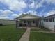 Shot of a modest house's rear exterior with a screened-in porch and a small yard at 1131 S Pershing Ave, Indianapolis, IN 46221